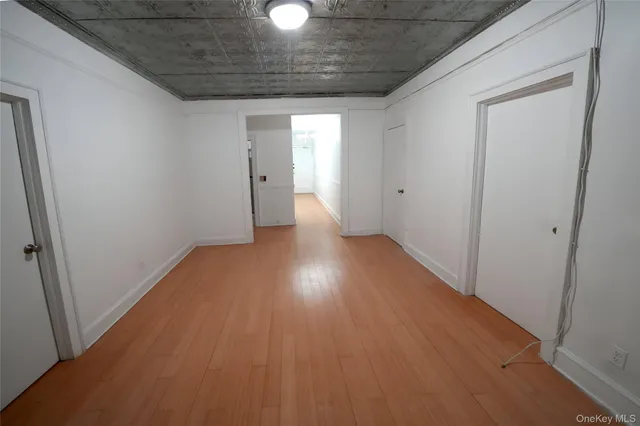 a view of hallway with wooden floor