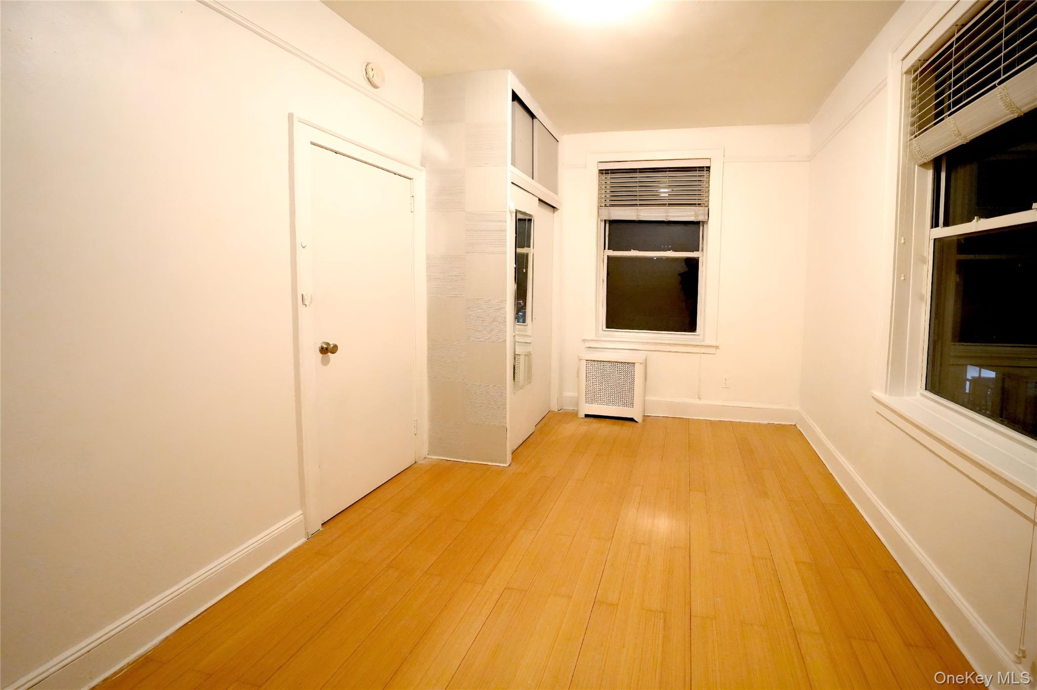 3775 64th Street, Unit 31 Queens, NY 11377 - Photo 10 of 18 a view of a livingroom with wooden floor and a flat screen tv