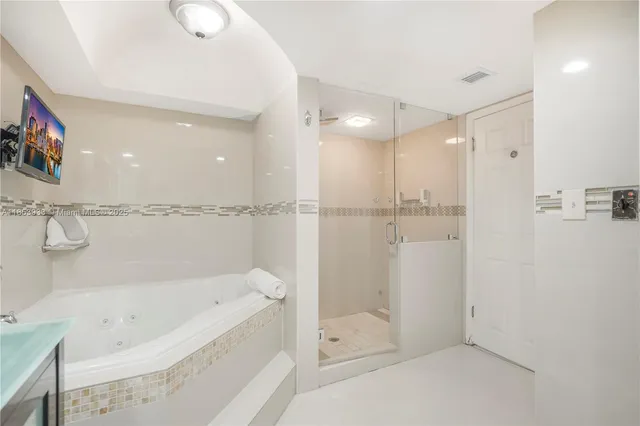 a bathroom with a bathtub and a shower