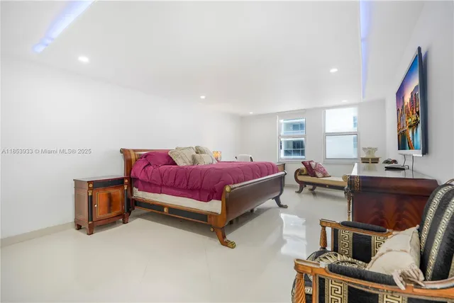 a bedroom with furniture and a mirror