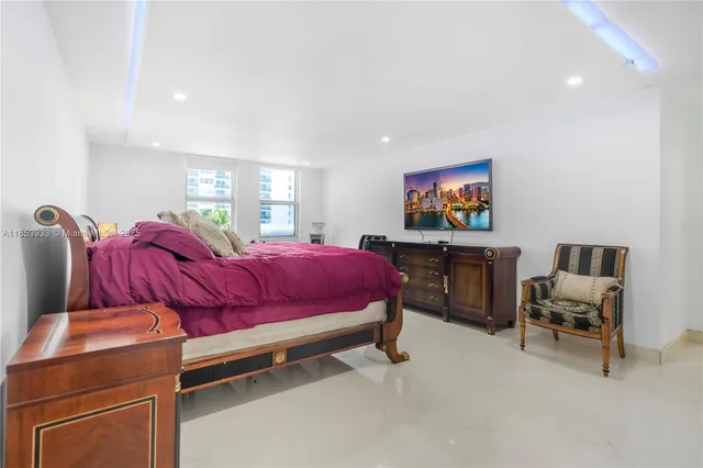 a bed room with two bed and a chair