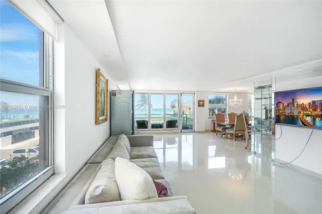 a living room with furniture and large windows