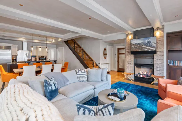 a living room with furniture kitchen view and a fireplace