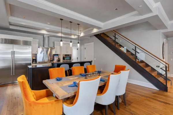 a dining room with furniture and wooden floor