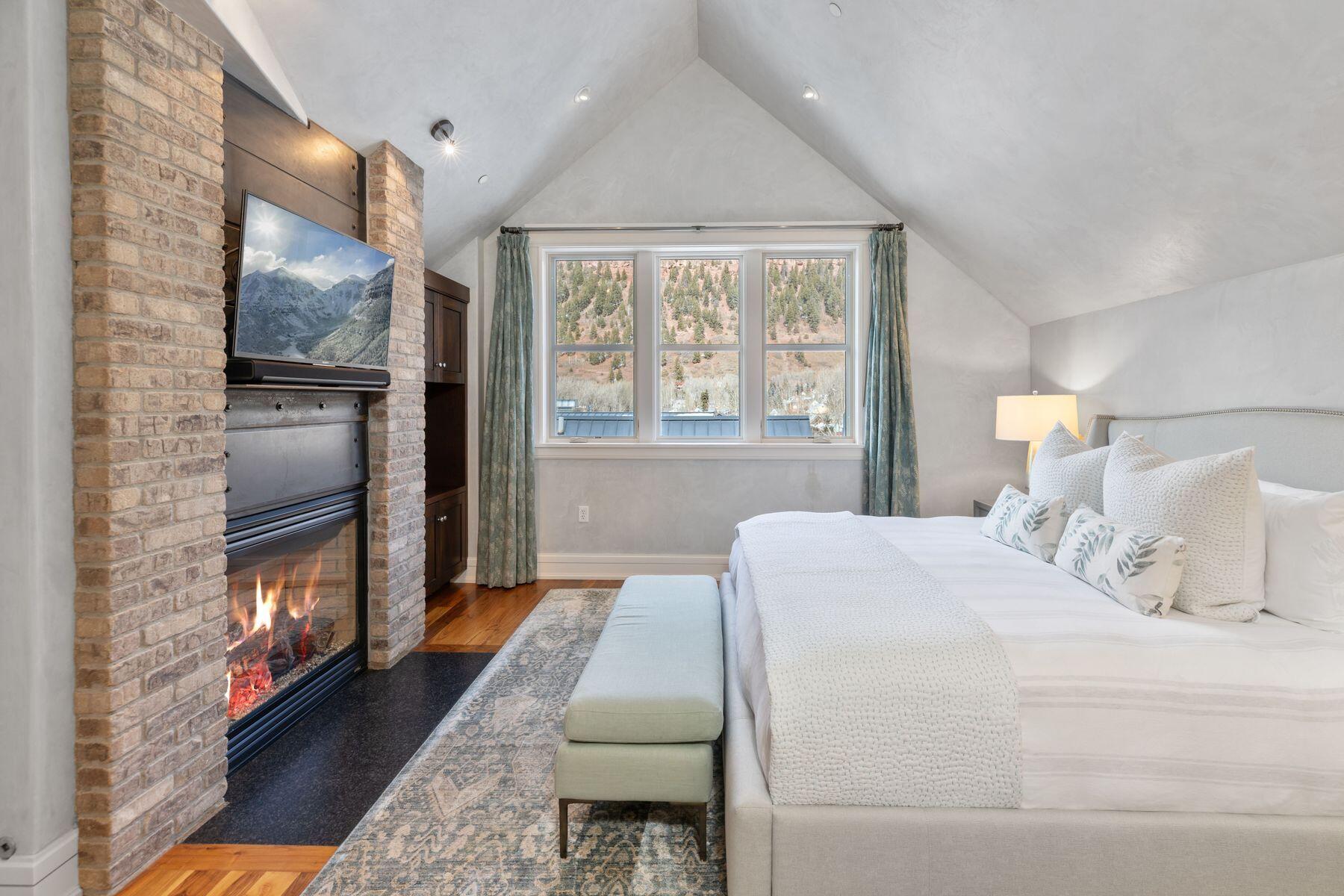 398 South Davis Street, Unit SW402 Telluride, CO 81435 - Photo 14 of 44 a bedroom with a bed table and window