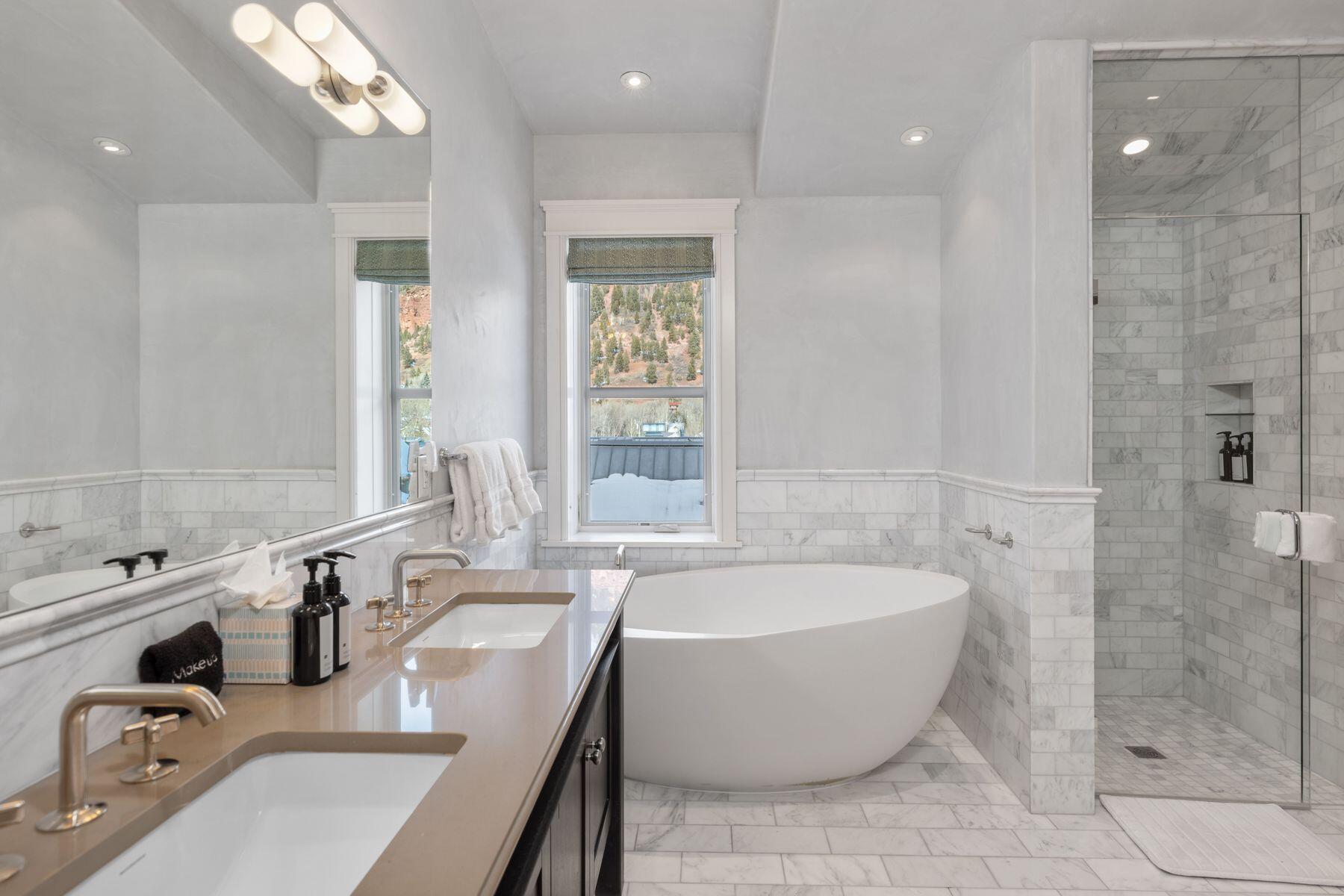 398 South Davis Street, Unit SW402 Telluride, CO 81435 - Photo 17 of 44 a bathroom with a tub a sink and mirror