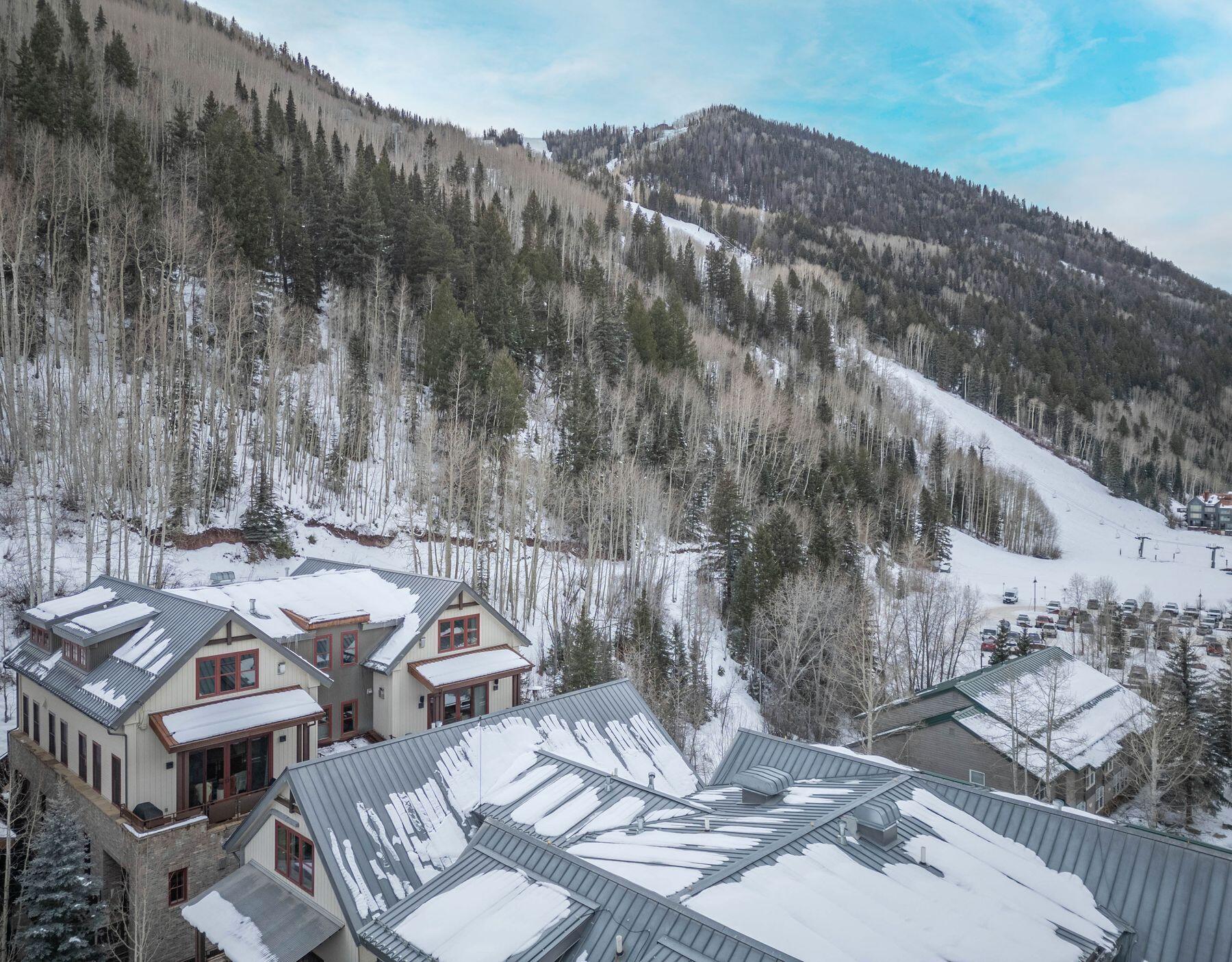 398 South Davis Street, Unit SW402 Telluride, CO 81435 - Photo 32 of 44 a picture of table and chairs with wooden fence
