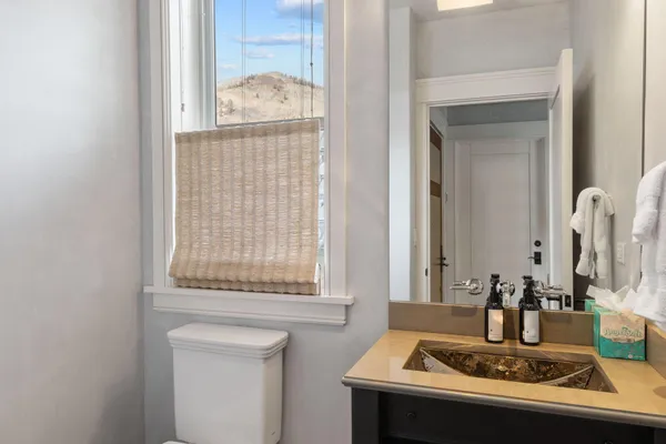 a bathroom with a double vanity sink a mirror and a bathtub