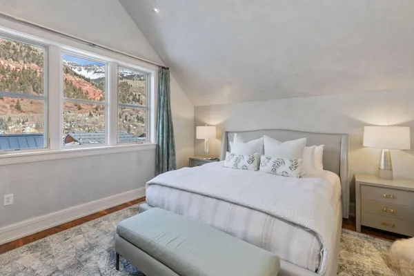 a bedroom with a bed and a window