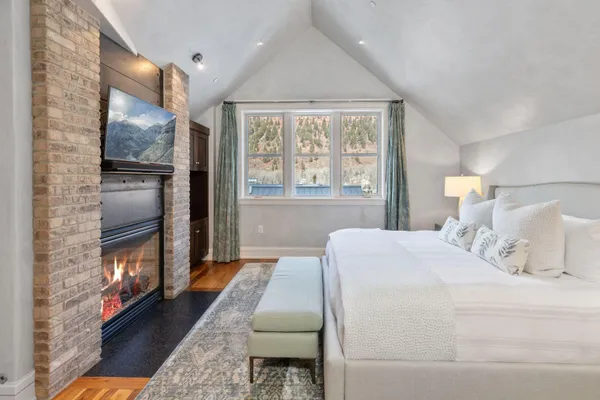 a bedroom with a bed table and window