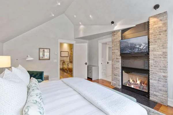 a bedroom with a bed and a fireplace