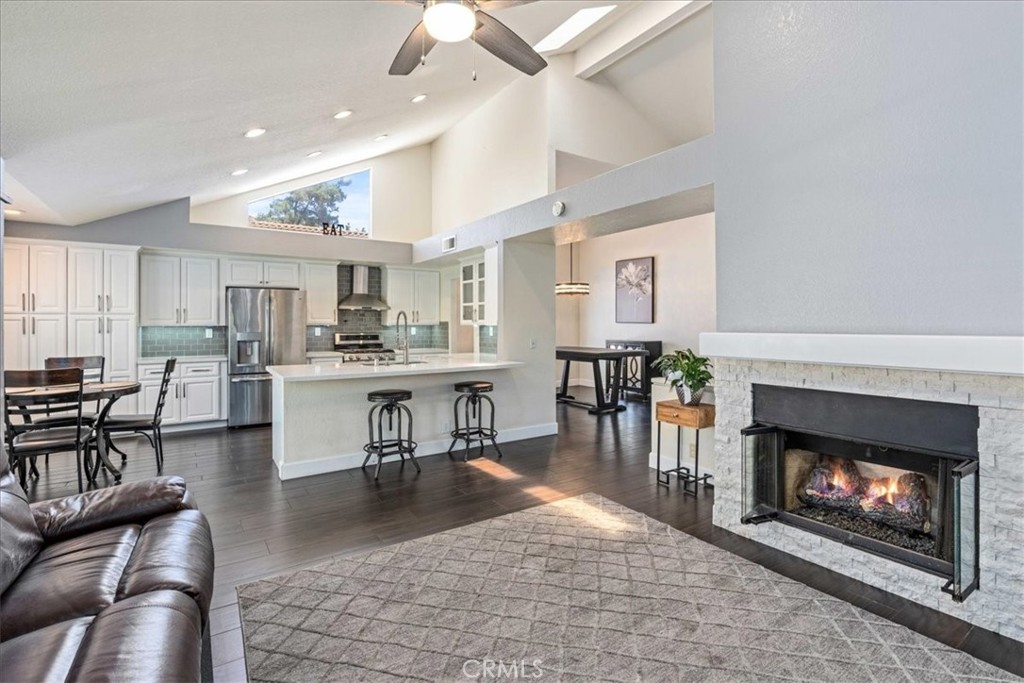 106 Bracebridge Court Riverside, CA 92506 - Photo 10 of 48 a living room with furniture a fireplace and kitchen view