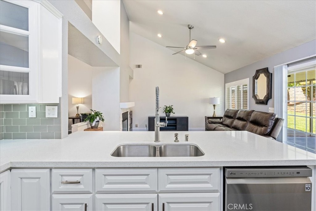 106 Bracebridge Court Riverside, CA 92506 - Photo 13 of 48 a kitchen with a faucet a chandelier and living room view