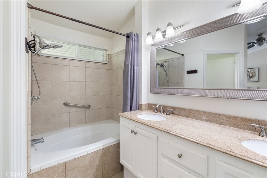 106 Bracebridge Court Riverside, CA 92506 - Photo 20 of 48 a bathroom with a granite countertop sink a mirror a shower and a bathtub