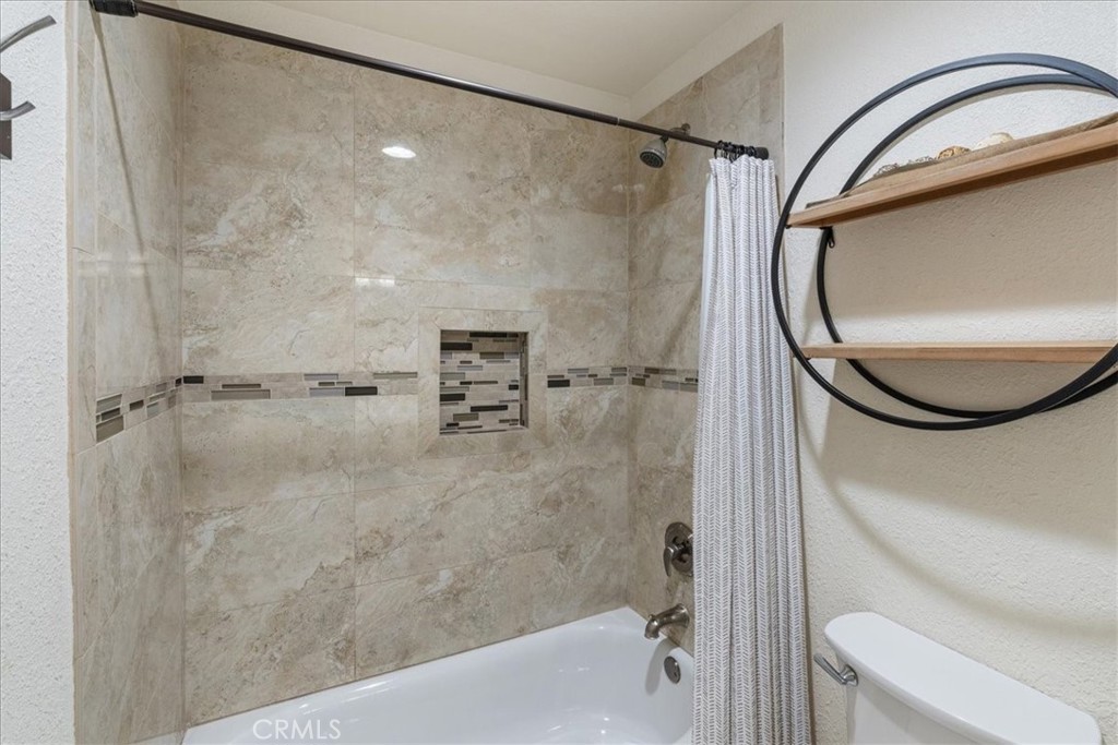 106 Bracebridge Court Riverside, CA 92506 - Photo 24 of 48 a bathroom with a shower a toilet and a mirror