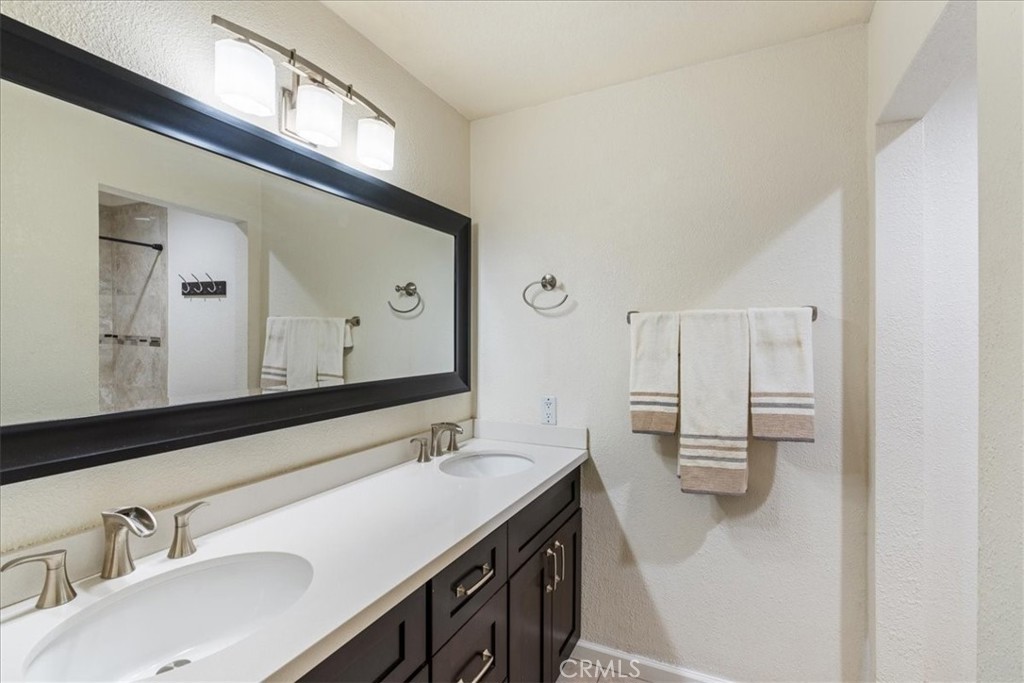 106 Bracebridge Court Riverside, CA 92506 - Photo 25 of 48 a bathroom with a sink and a mirror