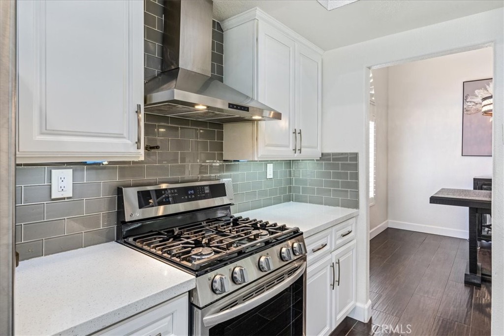 106 Bracebridge Court Riverside, CA 92506 - Photo 9 of 48 a kitchen with a stove and white cabinets