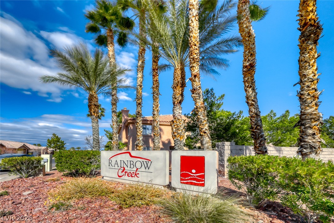 205 Genesee Point Street Henderson, NV 89074 - Photo 24 of 30 Towering palm trees frame the monument sign at the entrance of this tiled-roof community.