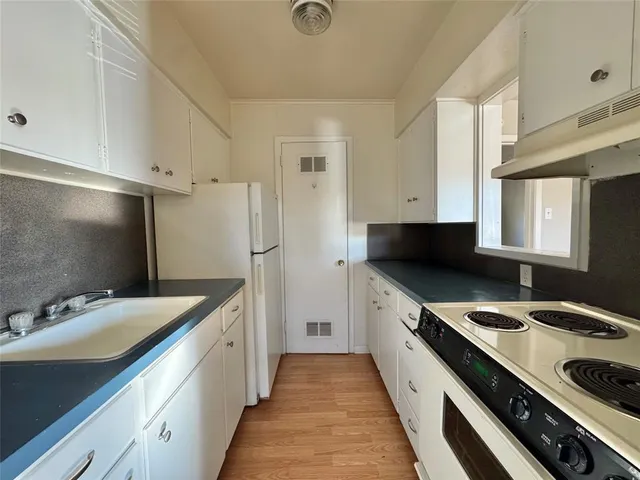 a kitchen with a sink stove and refrigerator