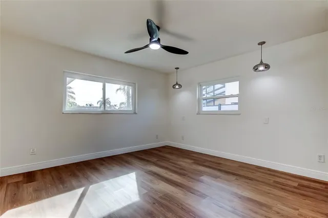 a bathroom with a granite countertop toilet sink and mirror