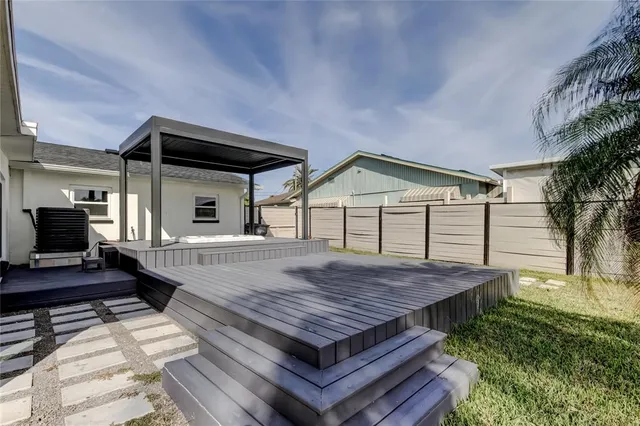 a view of a house with barbeque and wooden floor