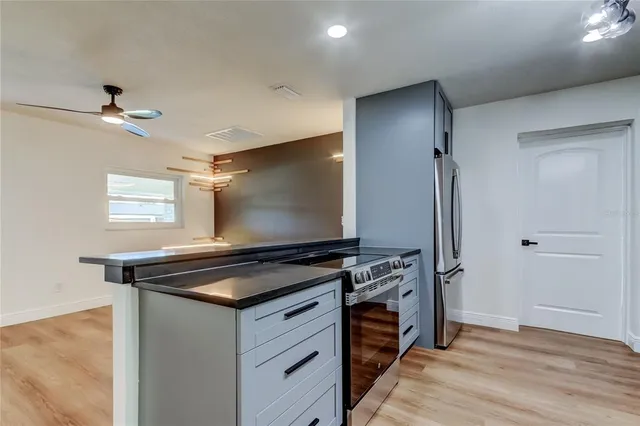 a view of empty room with wooden floor and floor to ceiling window