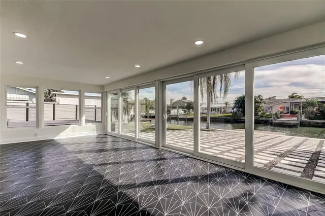 a view of a room with wooden floor and door