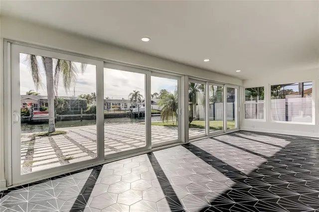 a view of a hallway with wooden floor and a bathroom