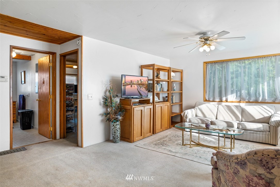 3037 Talbot Road South Renton, WA 98055 - Photo 9 of 29 a bed room with a bed and a chandelier