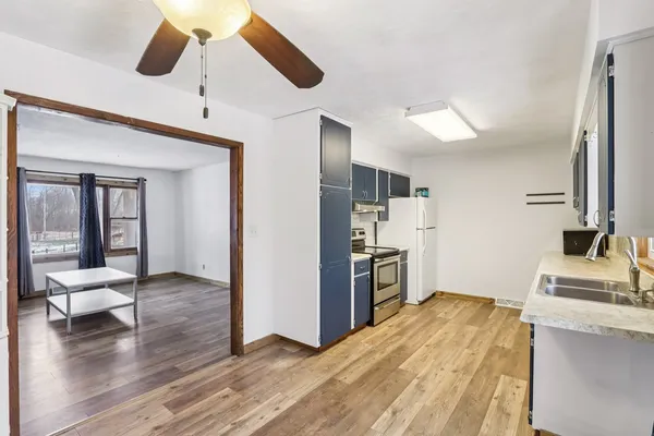 a kitchen with a stove a refrigerator and a sink