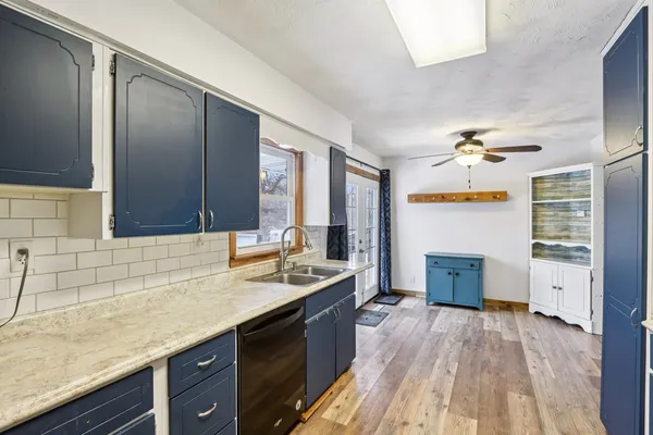 a spacious bathroom with a granite countertop sink mirror and bathtub