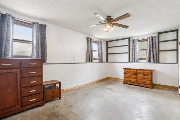 wooden floor & a ceiling fan in a room
