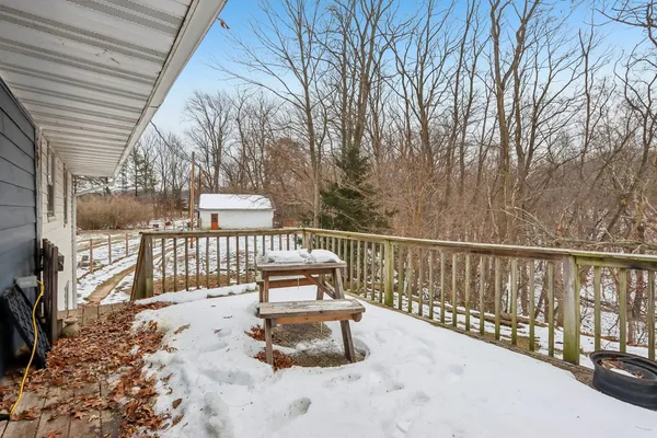 a view of white house with a yard and covered with snow