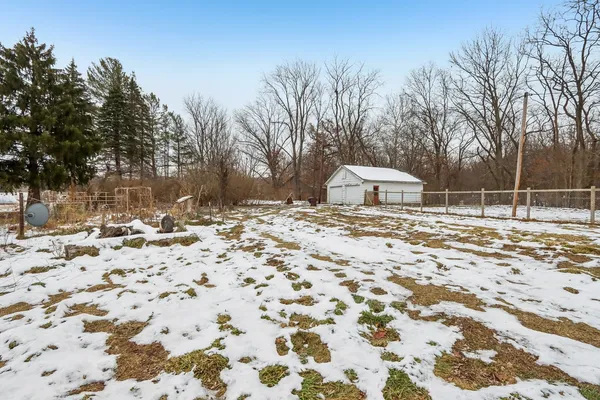 a view of a house with a yard covered in snow