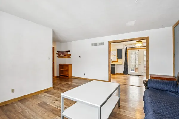 a room with wooden floor and a fireplace