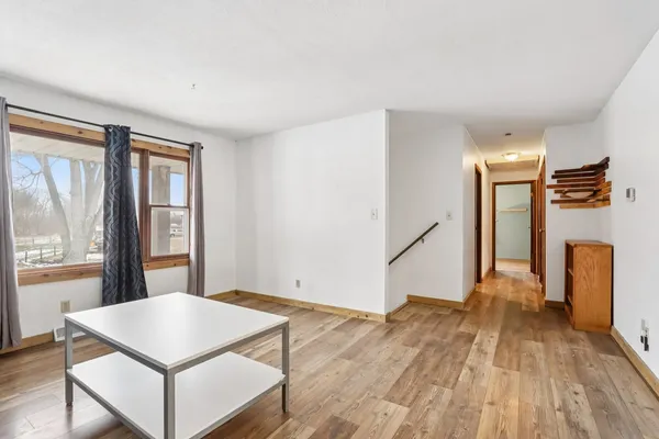 a view of a room with wooden floor and staircase