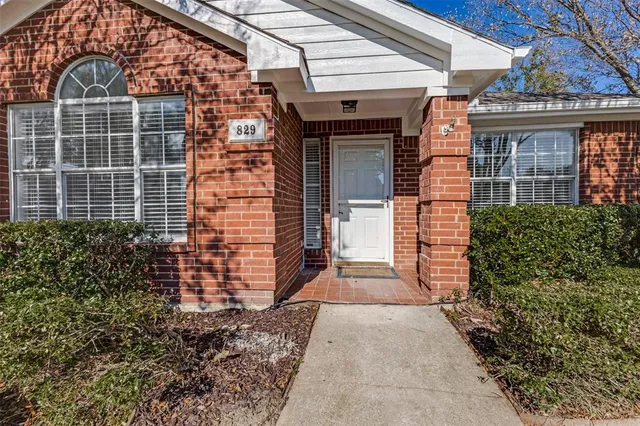 a view of a brick house with many windows