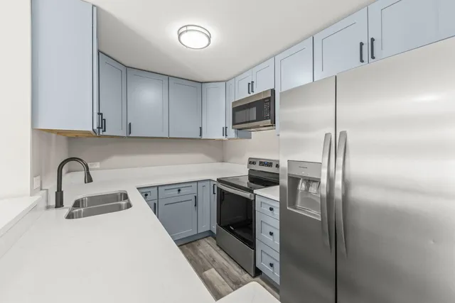 a kitchen with a sink a stove and refrigerator