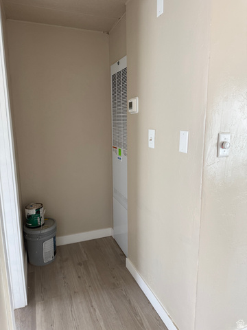 446 Riverside Drive, Unit 24 Wellington, UT 84542 - Photo 8 of 14 Hallway featuring light wood-style flooring and a heating unit