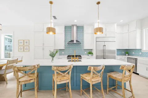 a kitchen with a dining table and chairs