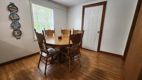 a view of a dining room with furniture and window