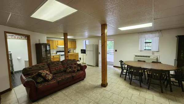 a living room with furniture a dining table and chairs