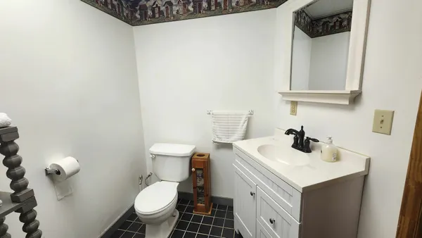 a bathroom with a sink toilet and mirror