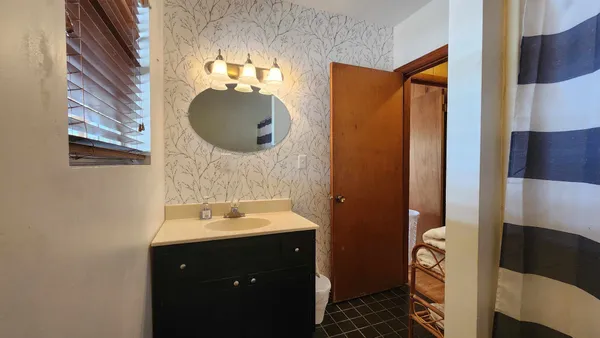 a bathroom with a sink and a mirror