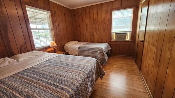 a bedroom with double bed and a window