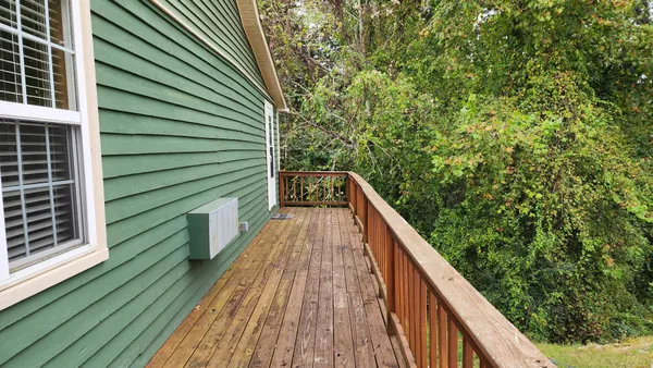 a view of balcony with wooden floor