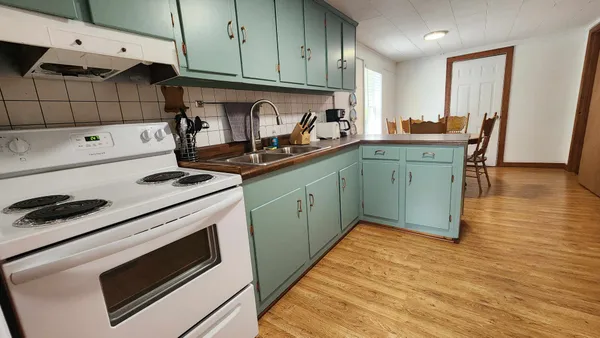 a kitchen with stainless steel appliances granite countertop a sink stove and cabinets