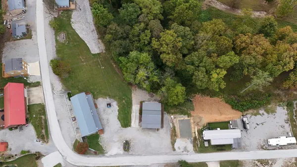 an aerial view of a house with a yard