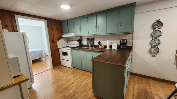 a kitchen with a refrigerator a stove top oven a sink and dishwasher
