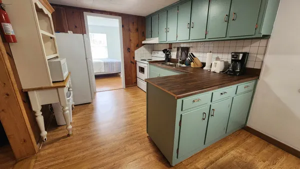 a kitchen with stainless steel appliances granite countertop a refrigerator sink and cabinets